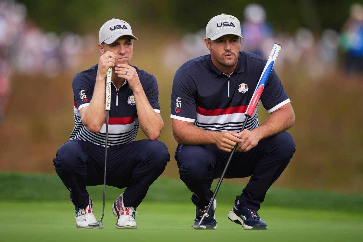 United States' and Justin Thomas and Bryson DeChambeau line up a putt on the 11th hole at ...