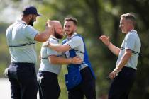 Europe's Jon Rahm, Tyrrell Hatton and captain Luke Donald celebrate after their win on the ...