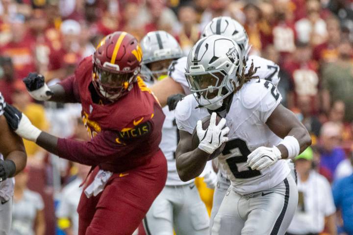 Raiders running back Ashton Jeanty (2) runs against Washington Commanders defensive tackle Jaly ...