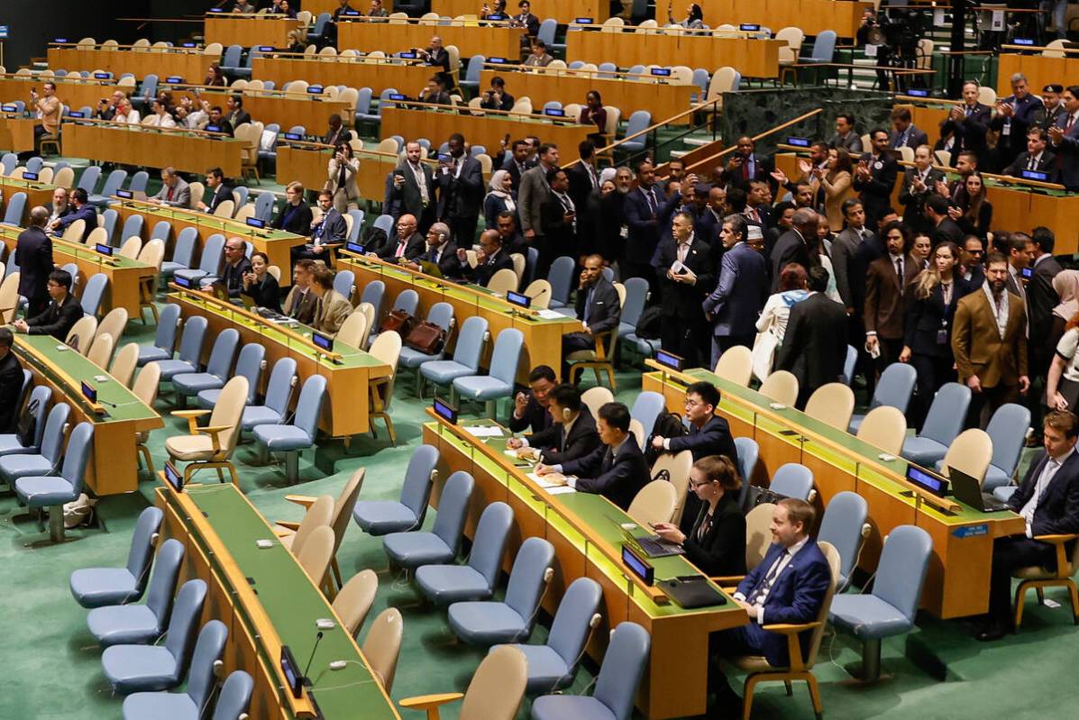Delegates leave the General Assembly hall as Israeli Prime Minister Benjamin Netanyahu steps up ...