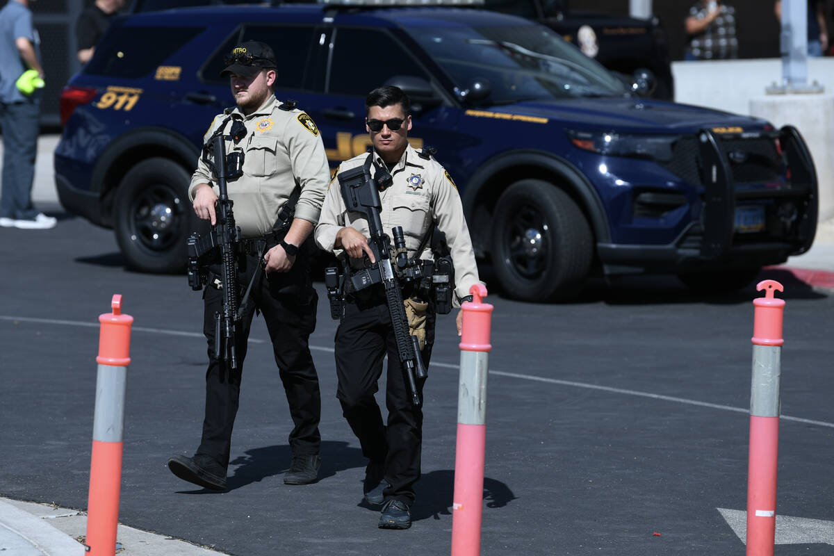 Metro officers leave with their rifles during a lockdown at Roy Martin Middle School Friday, Se ...