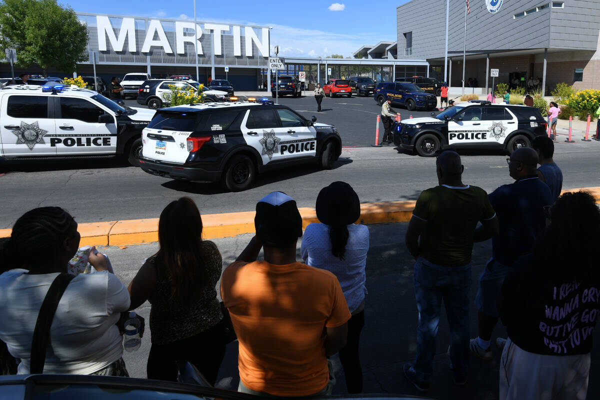 Parents and loved ones wait across the street during a lockdown at Roy Martin Middle School Fri ...