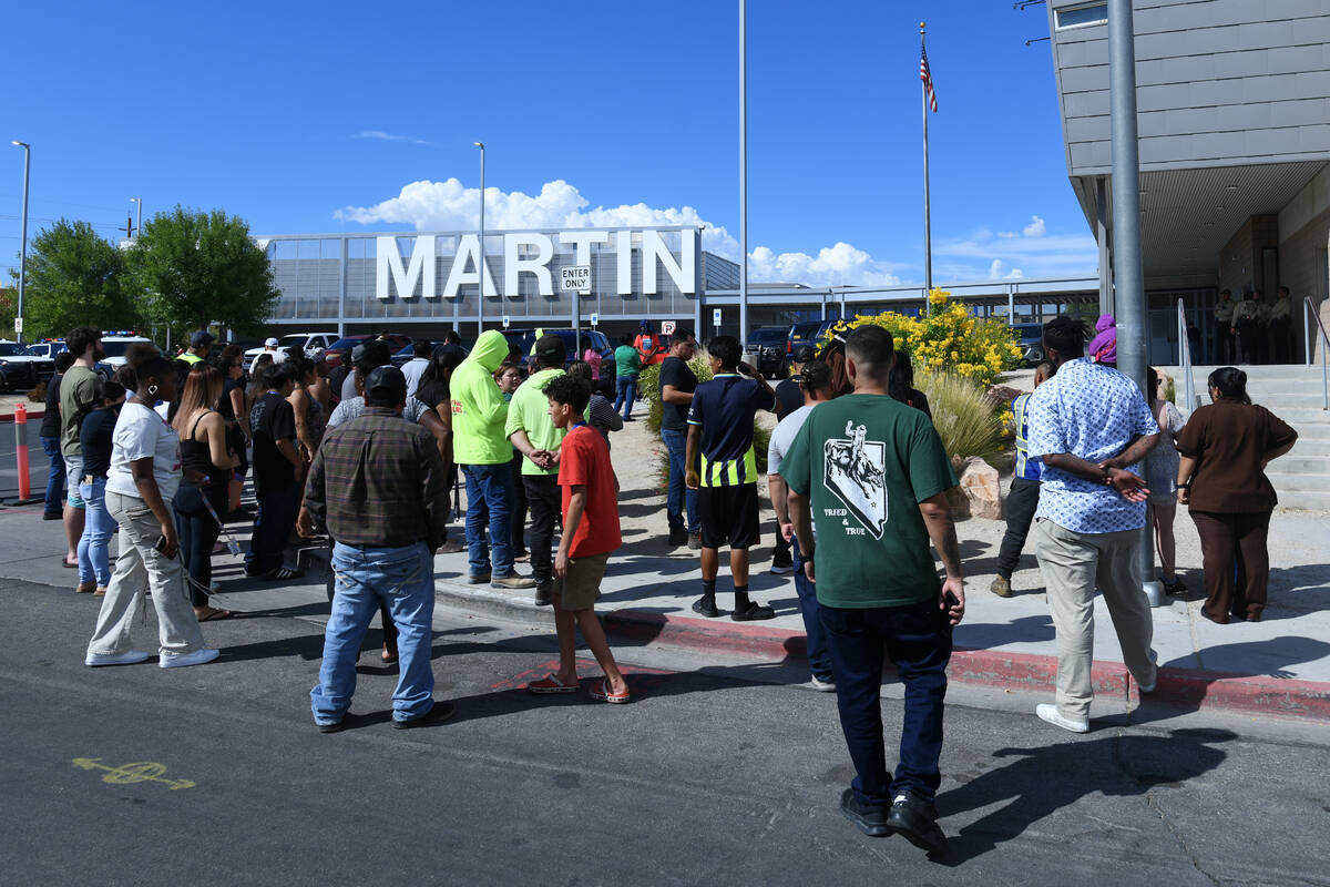 Parents and loved ones wait outside the school during a lockdown at Roy Martin Middle School Fr ...