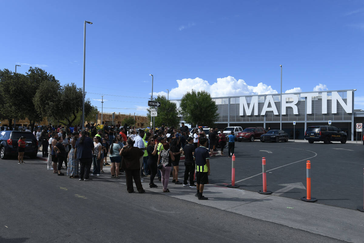 Parents and loved ones wait outside the school during a lockdown at Roy Martin Middle School Fr ...
