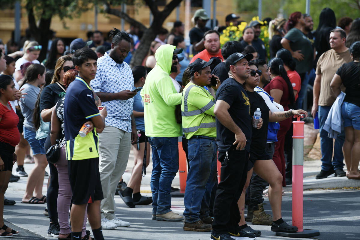 Parents and loved ones wait outside the school during a lockdown at Roy Martin Middle School Fr ...