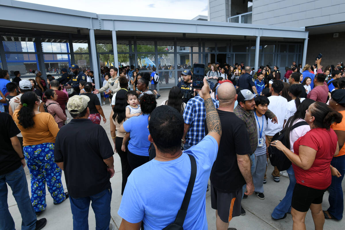 Parents wait for their children to be released during a lockdown at Roy Martin Middle School Fr ...