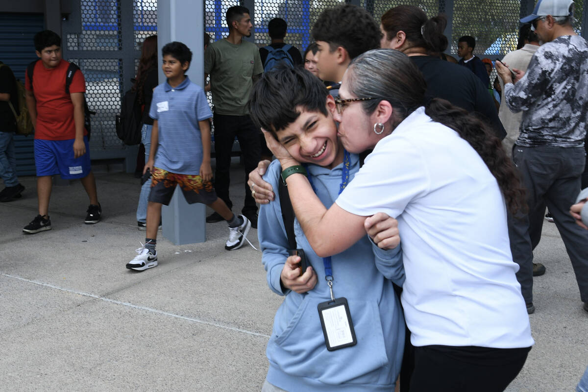 Angel Hernandez gets a kiss from his mother Veronica Hernandez after he was released during a l ...