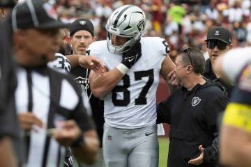 Raiders tight end Michael Mayer (87) comes off of the field with the help of trainers after suf ...