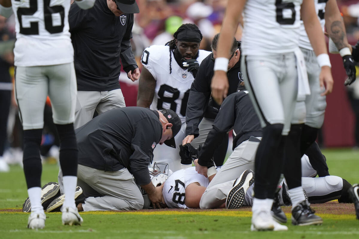 Las Vegas Raiders tight end Michael Mayer (87) lies on the field after a play during the first ...