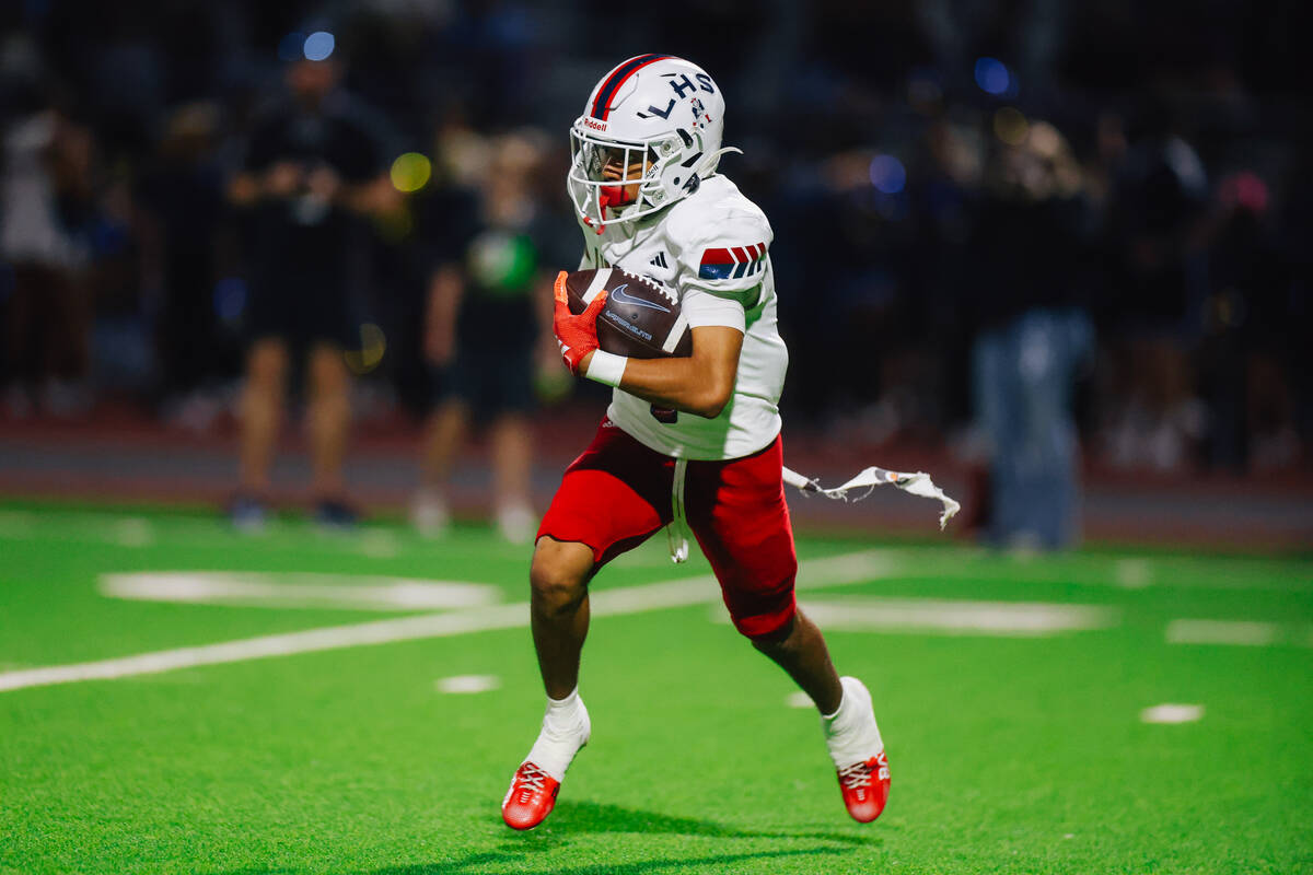 Liberty wide receiver Kaden Cadang (4) runs the ball during a high school football game between ...