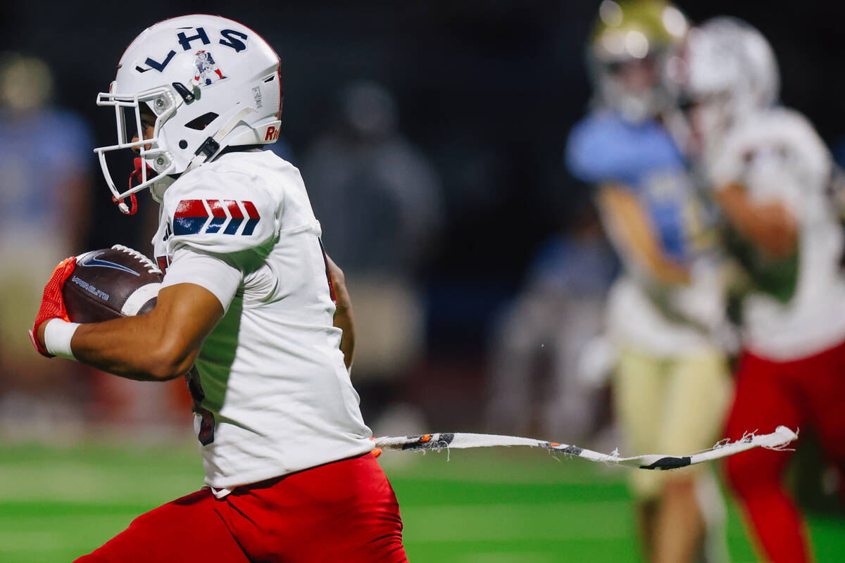 Liberty wide receiver Kaden Cadang (4) runs the ball during a high school football game between ...