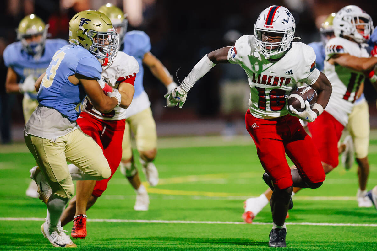 Liberty tight end Aiden Webster (18) runs the ball during a high school football game between L ...