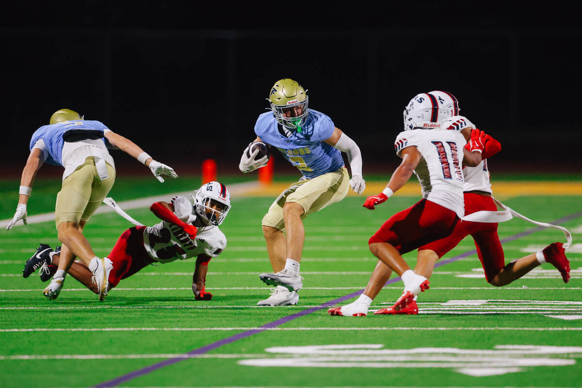 Foothill wide receiver Nixon Gasperosky (2) dodges defenders with the ball during a high school ...