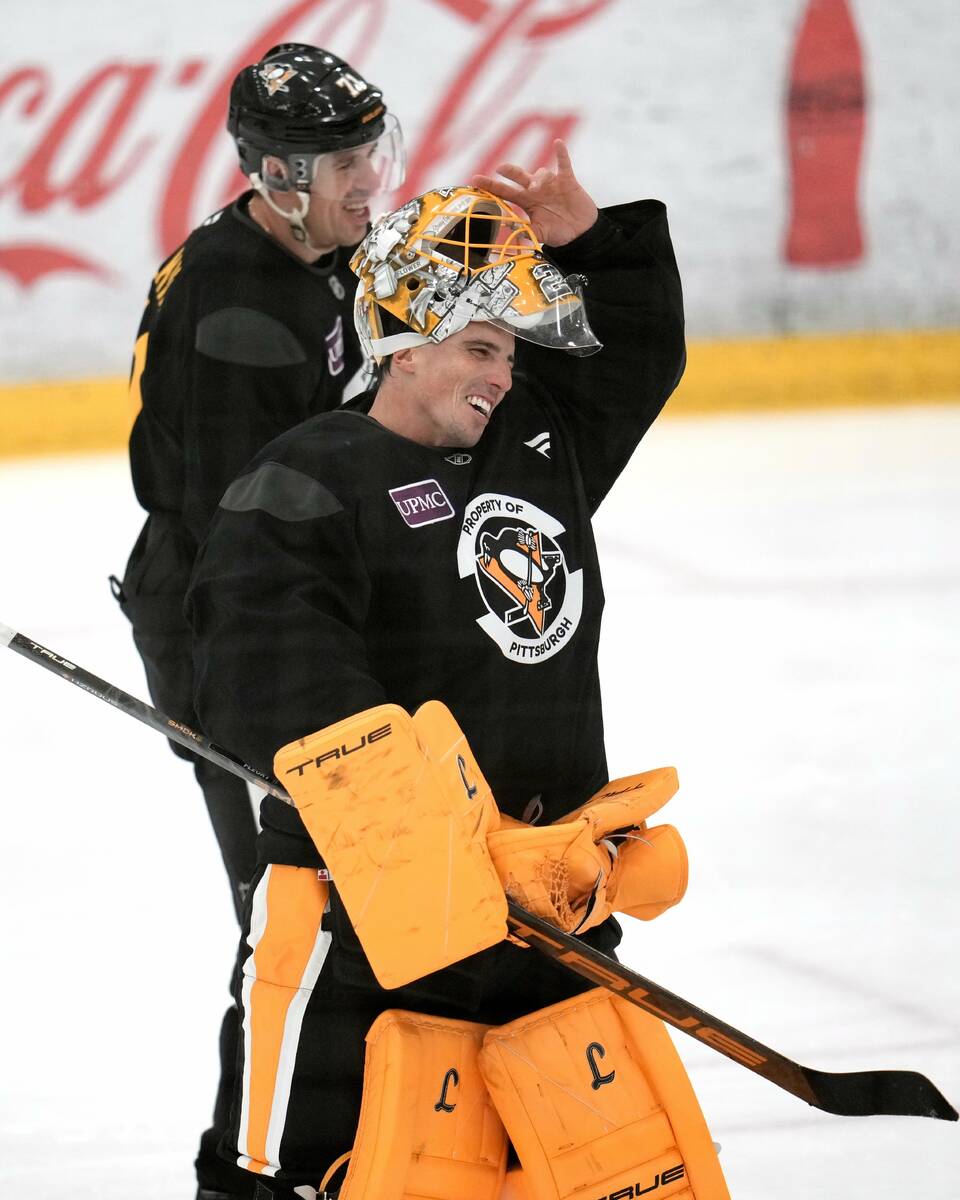 Pittsburgh Penguins goalie Marc-Andre Fleury, front, and Evgeni Malkin take a break during the ...