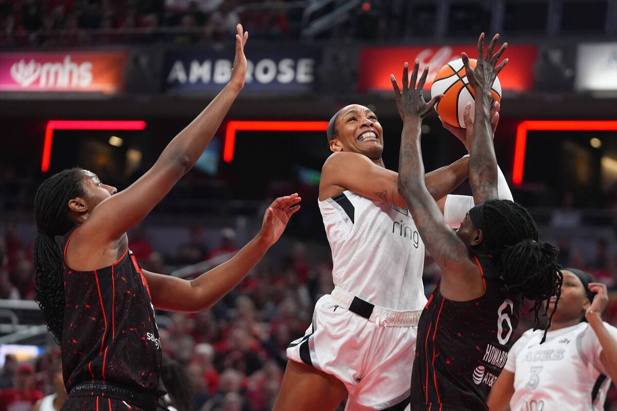 Las Vegas Aces' A'ja Wilson puts up a shot against Indiana Fever's Aliyah Boston ...