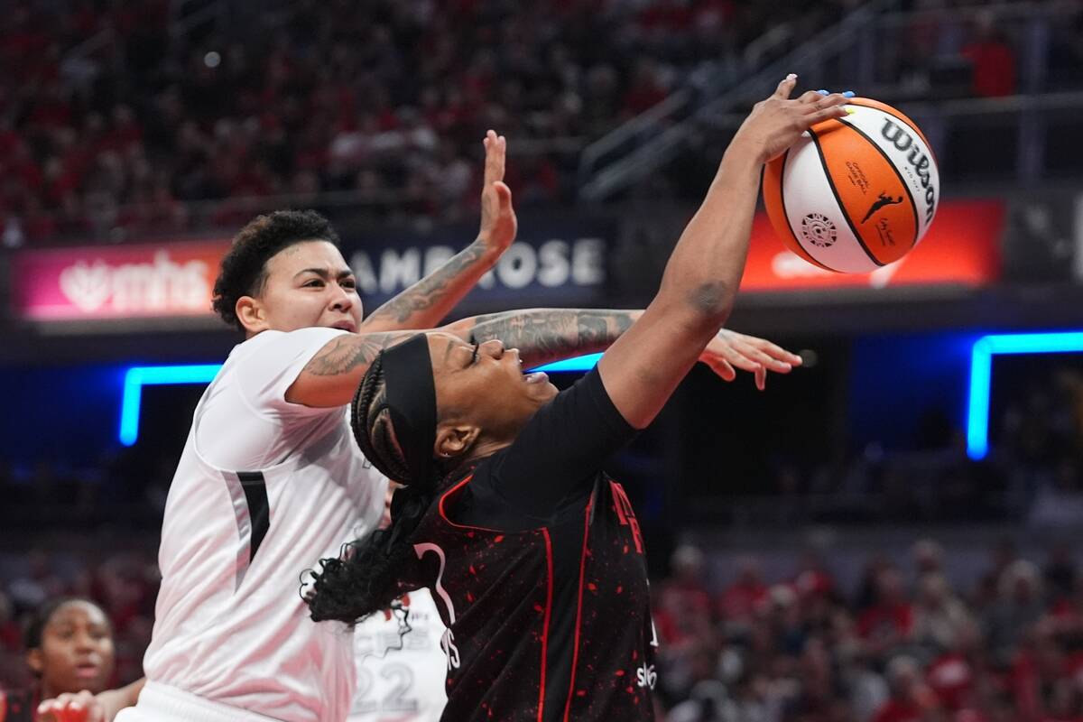 Indiana Fever's Odyssey Sims, right, has her shot blocked by Las Vegas Aces' Kierstan ...