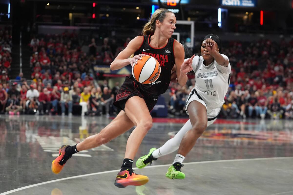 Indiana Fever's Lexie Hull, left, goes to the basket against Las Vegas Aces' Dana Eva ...