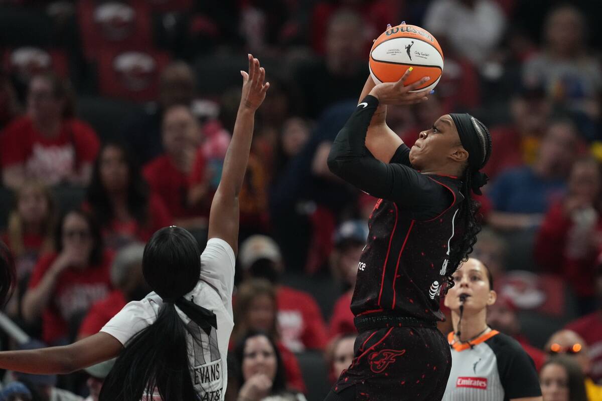 Indiana Fever's Odyssey Sims (1) shoots over dLas Vegas Aces' Dana Evans (11) during ...