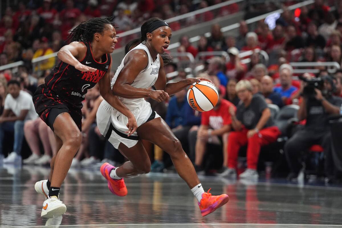 Las Vegas Aces' Jackie Young (0) goes to the basket against Indiana Fever's Kelsey Mi ...