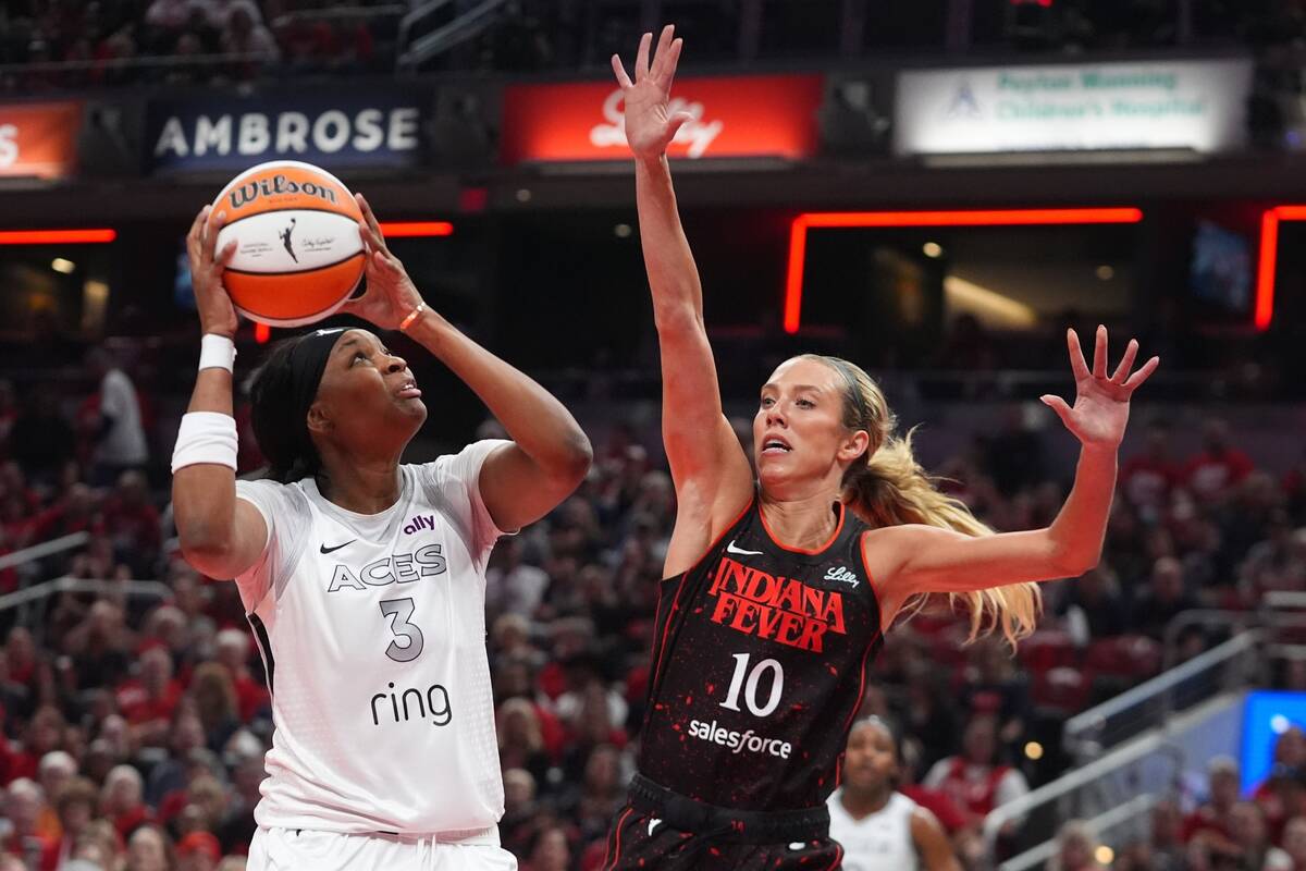 Las Vegas Aces' NaLyssa Smith (3) shoots over Indiana Fever's Lexie Hull (10) during ...