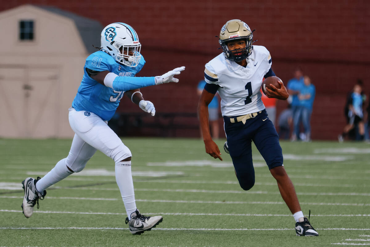 Sloan Canyon defensive lineman Jordan Frost (91) chases after Spring Valley quarterback Antwan ...