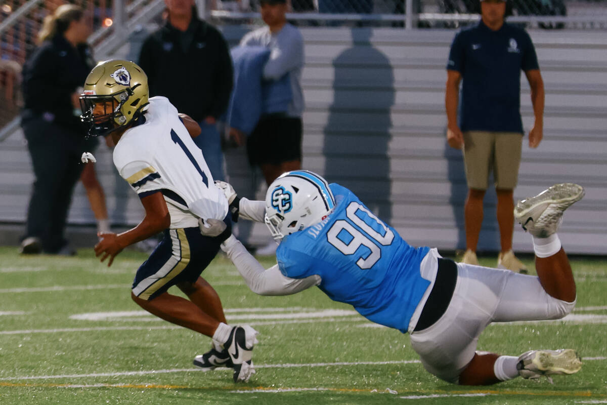 Sloan Canyon defensive lineman Simote Tupou (90) sacks Spring Valley quarterback Antwan Osborne ...