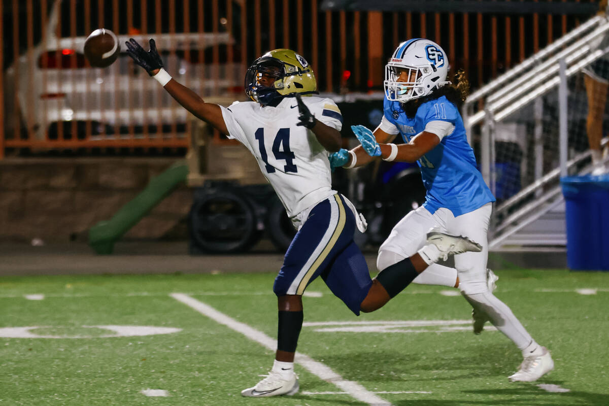 Spring Valley defensive back Johnny Stiger (14) tries to intercept a pass intended for Sloan Ca ...