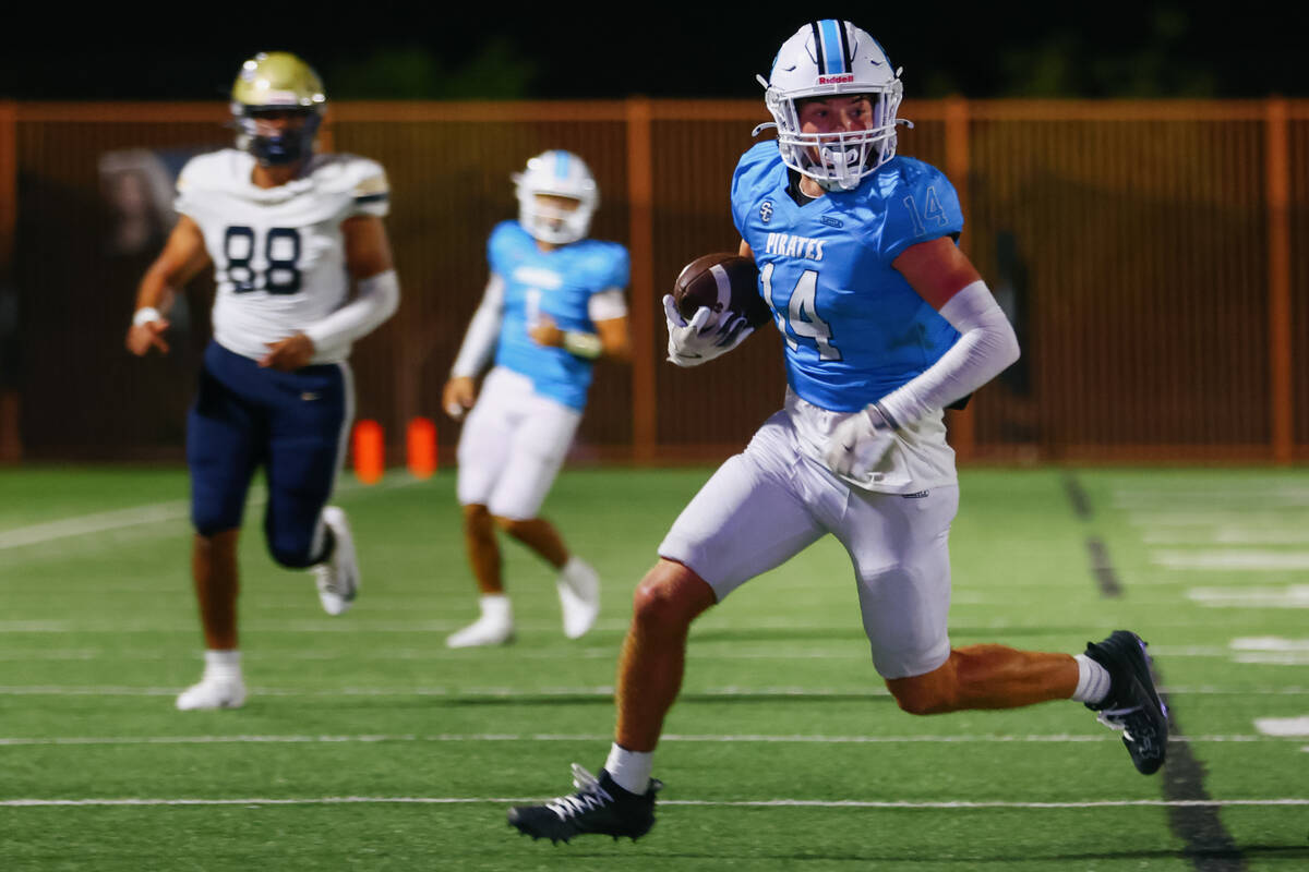 Sloan Canyon wide receiver Christian Rhodes (14) carries the ball upfield during the game on Fr ...