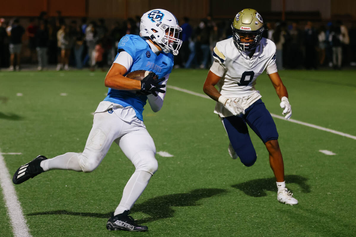 Sloan Canyon wide receiver Brandon Quaglio (2) pivots toward the end zone with Spring Valley de ...