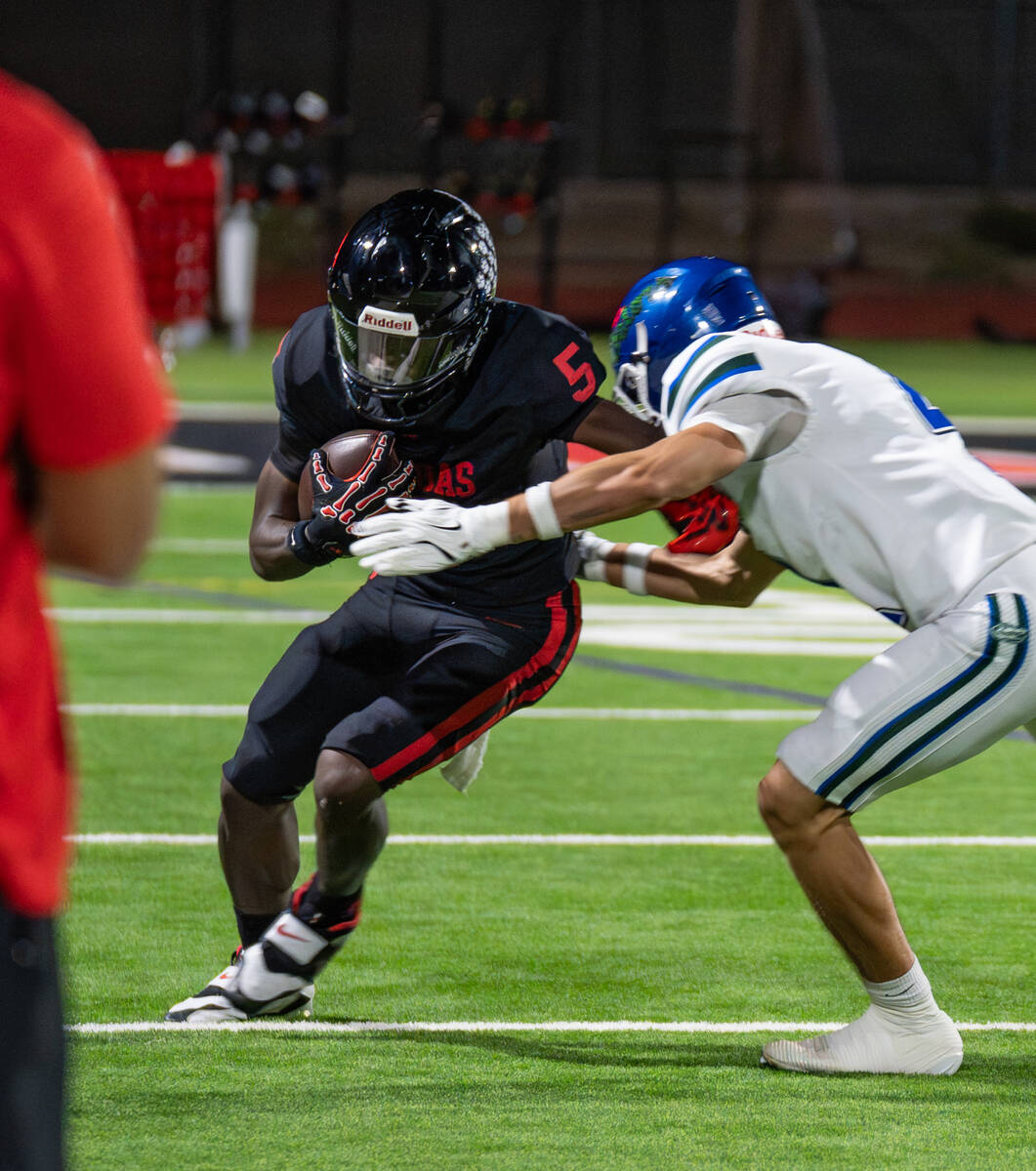 Las Vegas’s Dasean Deayon (5) avoids Green Valley’s DB Blake Brickhouse (4) during a footba ...
