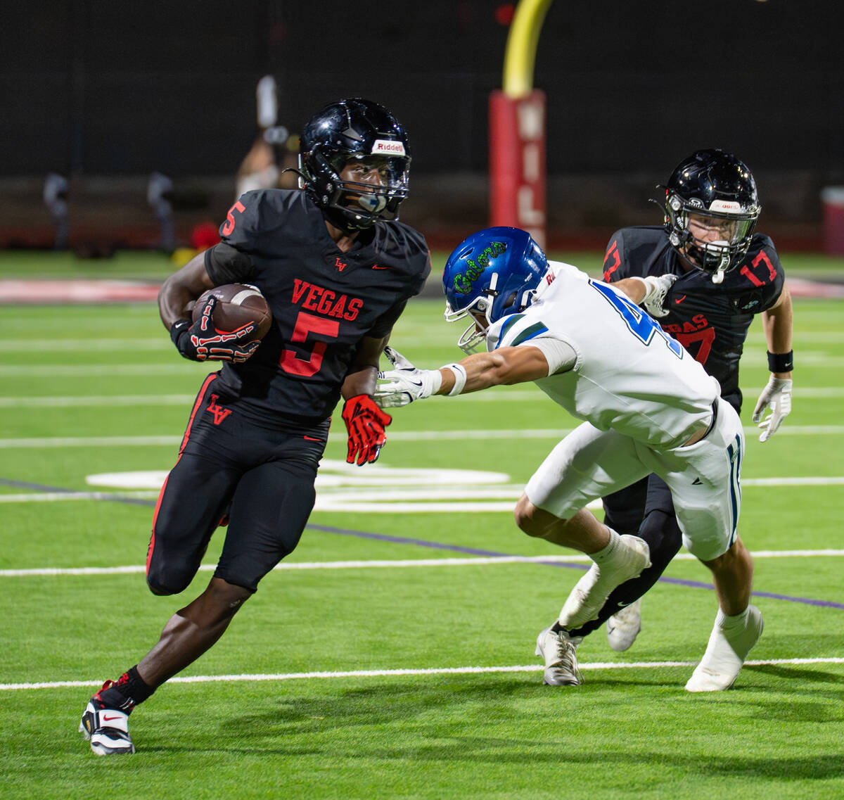 Las Vegas’s Dasean Deayon (5) avoids Green Valley’s DB Blake Brickhouse (4) during a footba ...