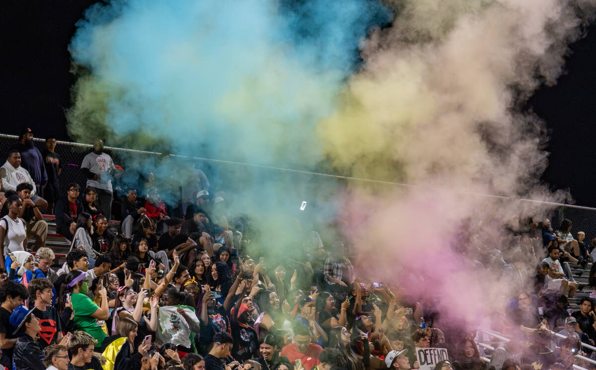 Colorful party poppers are let off over Las Vegas High School’s student section during t ...