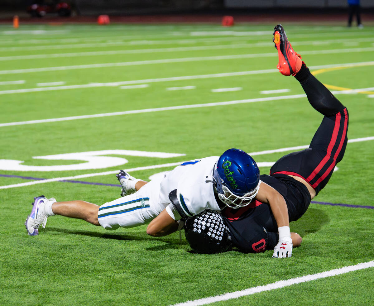 Las Vegas’s Sr. Max Lindaman (80) is brought down by Green Valley’s Bo Hackenbruc ...