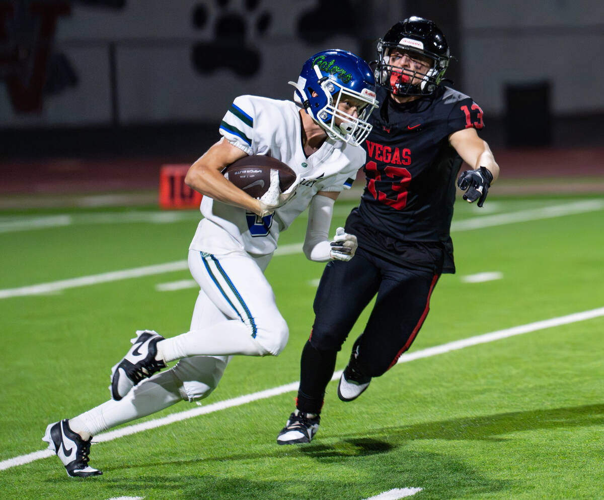 Green Valley’s Sam Byington (5) tries to avoid Las Vegas’s Logan Mendez (13) duri ...