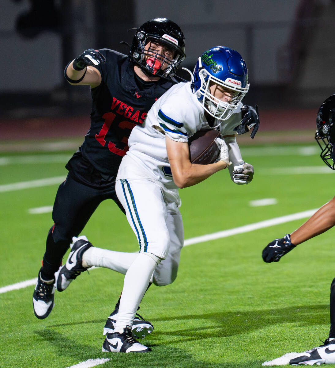 Green Valley’s Sam Byington (5) tries to avoid Las Vegas’s Logan Mendez (13) duri ...