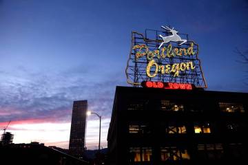 FILE - The "Portland, Oregon" sign is seen atop in building in downtown Portland, Ore ...