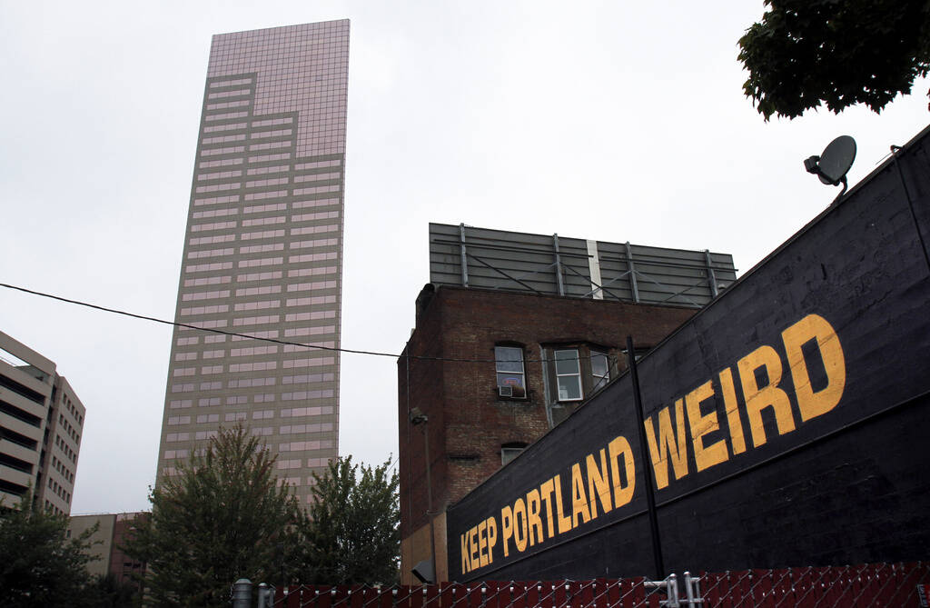 FILE - A downtown building displays a popular slogan in relation to the city in Portland, Ore., ...