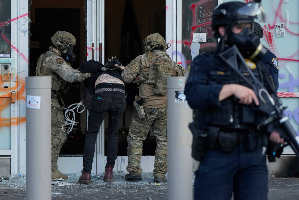 FILE - U.S. Customs and Border Protection agents detain a man outside the U.S. Immigration and ...