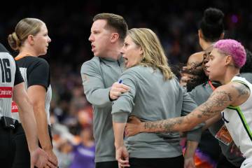 Minnesota Lynx head coach Cheryl Reeve, second from right, yells at officials as she is restrai ...