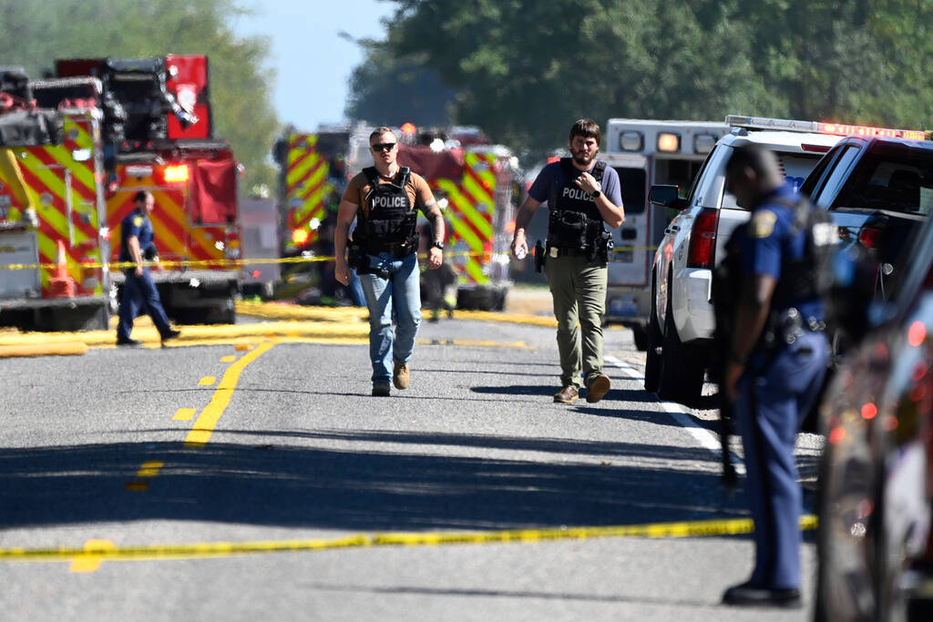 Law enforcement guard the area along McCandlish Road near a shooting that took place at The Chu ...