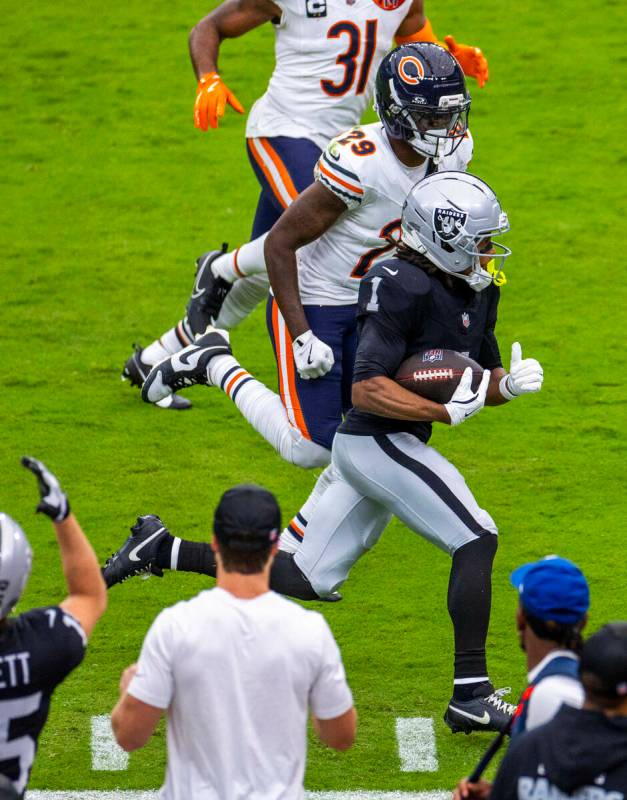 Raiders wide receiver Tre Tucker (1) runs down the sidelines as Chicago Bears cornerback Tyriqu ...