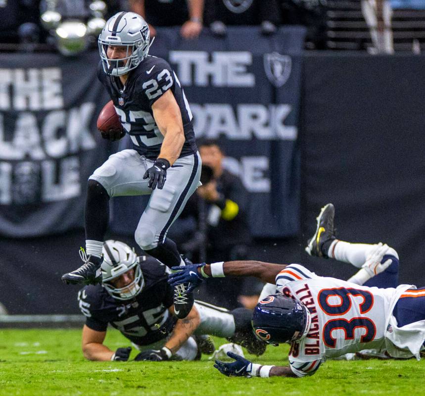 Raiders running back Dylan Laube (23) leaps past Chicago Bears cornerback Josh Blackwell (39) f ...