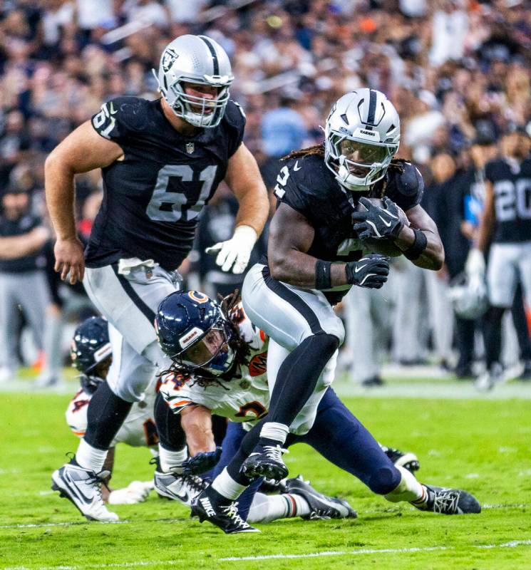 Raiders running back Ashton Jeanty (2) breaks free from a tackle attempt by Chicago Bears corne ...