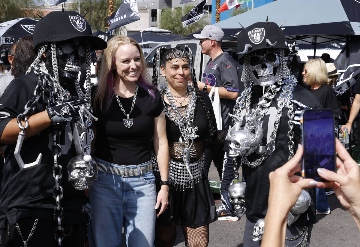 Jodi Kammeyer poses for photo with Rogers and Angela, second right, at tailgating area prior to ...