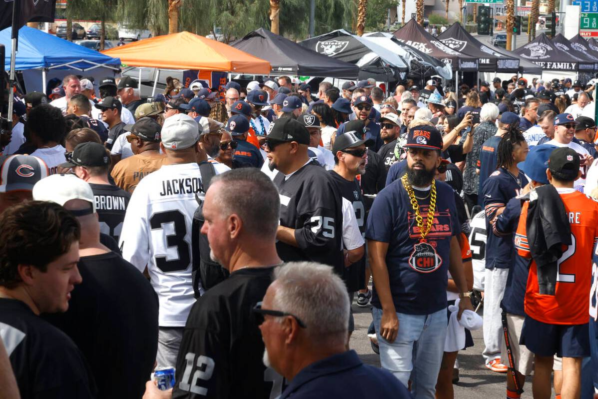 Raiders and Chicgo Bears fans gather at tailgatiing area prior to an NFL football game between ...