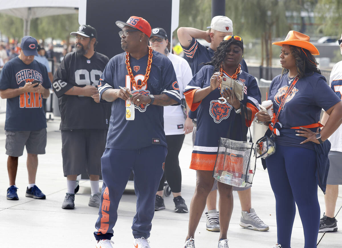 Raiders and Chicgo Bears fans stand in line prior to an NFL football game between Raiders and C ...
