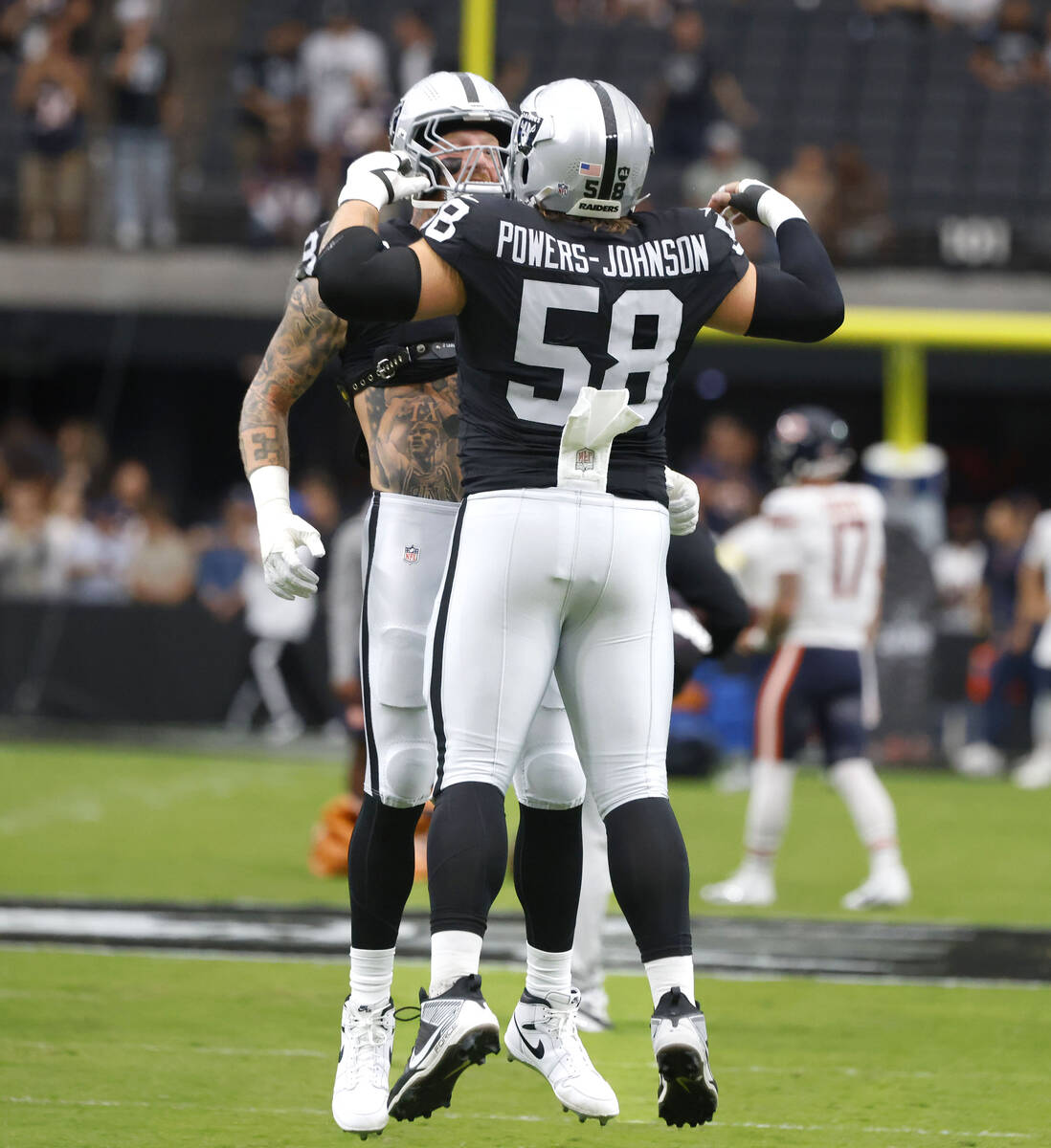 Raiders defensive end Maxx Crosby (98) and center Jackson Powers-Johnson (58) pump up prior to ...