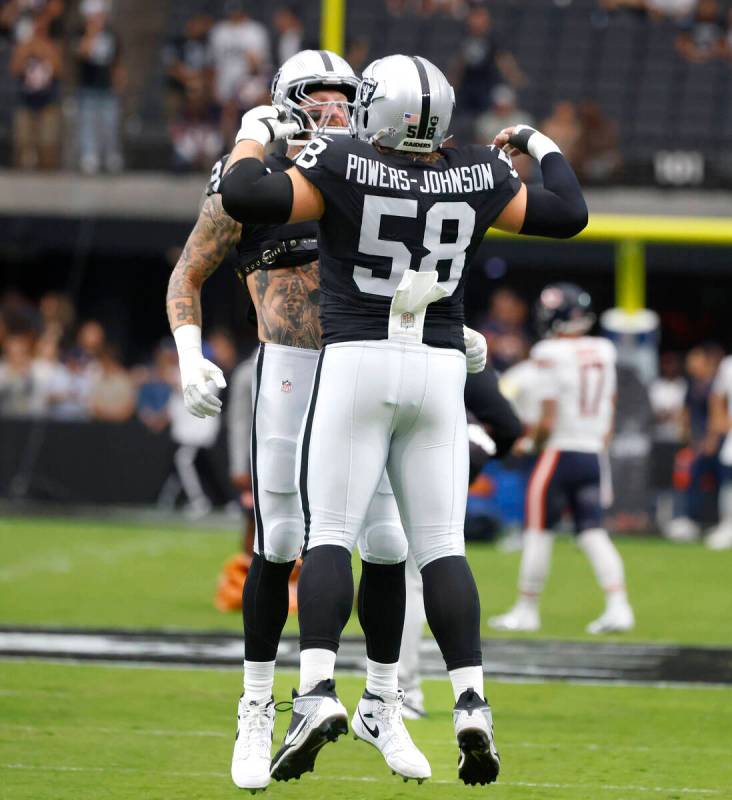 Raiders defensive end Maxx Crosby (98) and center Jackson Powers-Johnson (58) pump up prior to ...