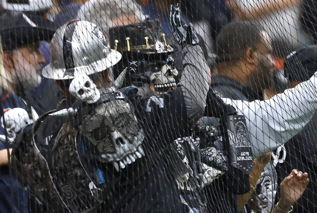 Raiders fans react as they watch the second half an NFL football game against Chicago Bears at ...