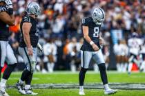 Raiders kicker Daniel Carlson (8) looks down after a deflection by Chicago Bears cornerback Jos ...